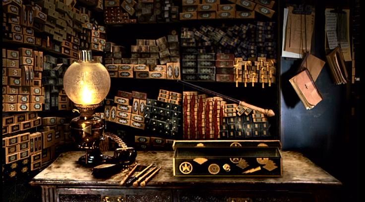 an old fashioned desk with some books on it and a lamp in the corner next to it