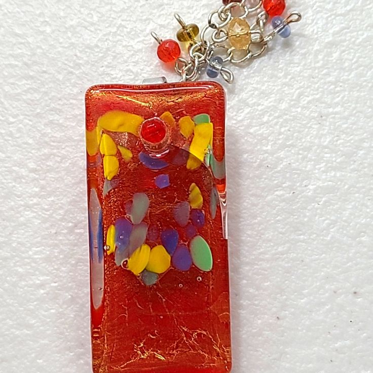 Nwot Glass Pendant. Colors Of Red, Yellow And Blue. It Can Be Worn With Either The Attached Crystals Behind The Piece Or In Front. The Pendant Is Silver In Color. Never Worn. Received As A Gift. Smoke And Pet Free Home. Unique Red Glass Necklace, Handmade Red Glass Necklaces, Handmade Red Glass Necklace, Handmade Red Necklace With Rectangular Pendant, Handmade Red Artsy Necklace, Artsy Red Necklace For Gift, Handmade Red Artsy Necklaces, Colors Of Red, Made Jewelry