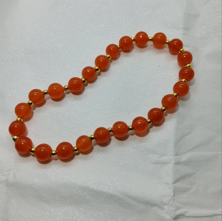 This Is A Beautiful Bracelet. The Tanzenite Is A Bright, Bold Color. It Looks Fantastic With The Gold. It Is A Stretch Bracelet, So Size Is A Little Flexible. For Reference, A 7" Bracelet Is My Usual Size. This One Fits My Wrist Perfectly. I Think It Could Fit Any Size Between 6.5" And 8". Orange Polished Beads Bracelet, Elegant Orange Beaded Bracelets With Gemstones, Elegant Orange Gemstone Beaded Bracelets, Hand-strung Orange Jewelry With Round Beads, Orange Hand-strung Jewelry With Round Beads, Elegant Orange Bracelet For Gift, Elegant Orange Jewelry With 8mm Beads, Gold Bracelet With Single Strand Round Beads, Orange Bracelets With 8mm Round Beads