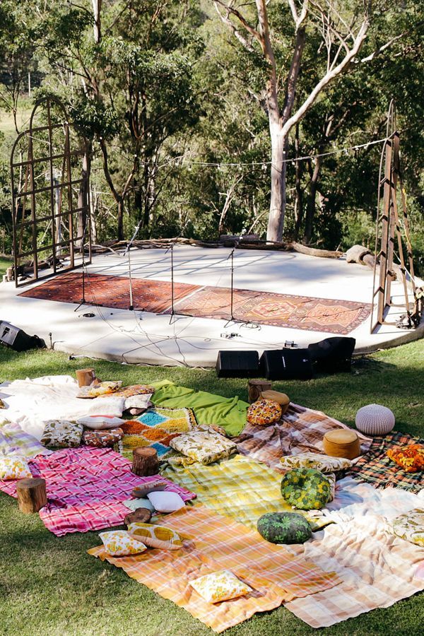 an outdoor picnic is set up in the grass with food on it and other items laid out