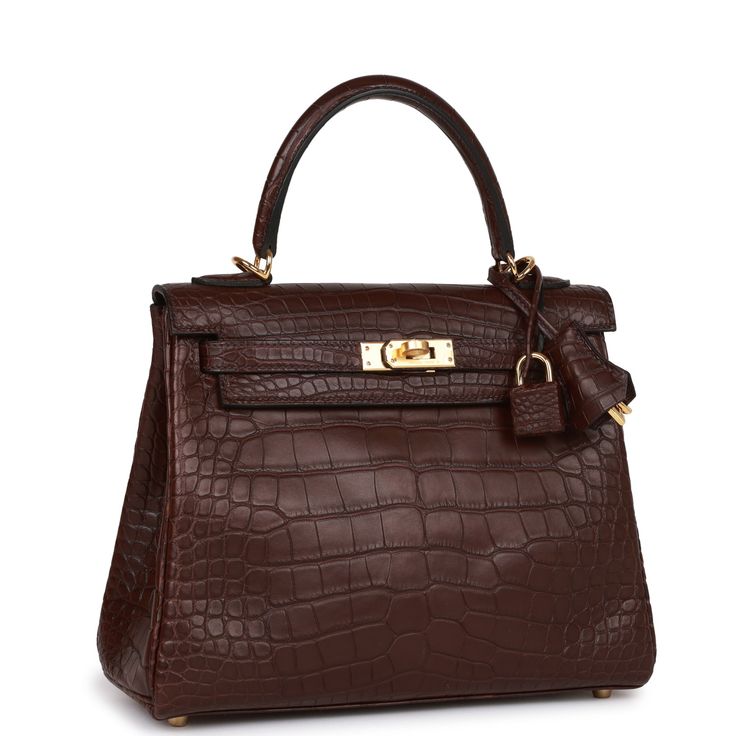 This Kelly, in the Retourne style, is in Rouge Sellier Matte Mississipiensis Alligator leather with gold hardware, tonal stitching, front flap with two straps, front toggle closure, clochette with lock and two keys, a single rolled handle, and removable shoulder strap. The interior is lined with Rouge Sellier chevre leather and has one open pocket on the back wall. Collection: UOrigin: FranceCondition: Pristine; new or never worn (plastic on hardware)Accompanied by: Hermes box, Hermes dustbag, shoulder strap, shoulder strap dustbag, felt, carebookMeasurements: 9.8' width x 7.5' height x 3.5' depth; 3.5' handle drop Hermes Kelly Retourne, Dark Luxury, Hermes Box, Handbag Heaven, Hermes Bags, Hand Bags, Bags Shoes, Alligator, Gold Hardware