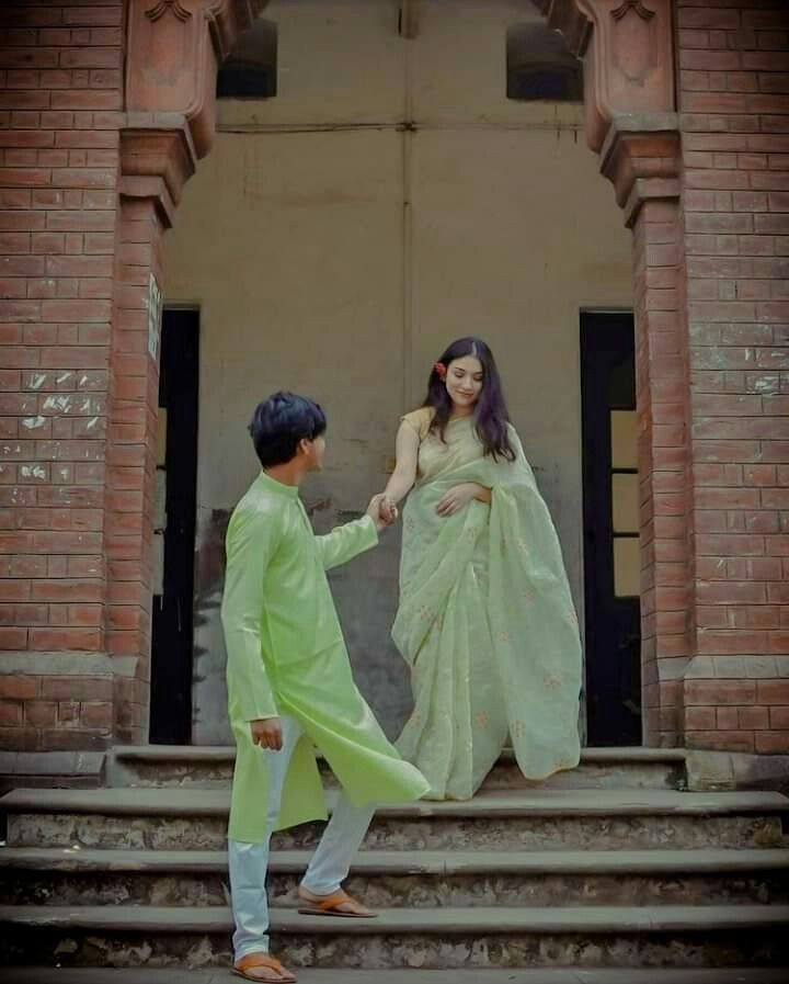 a man and woman are walking down the steps together, holding hands with each other