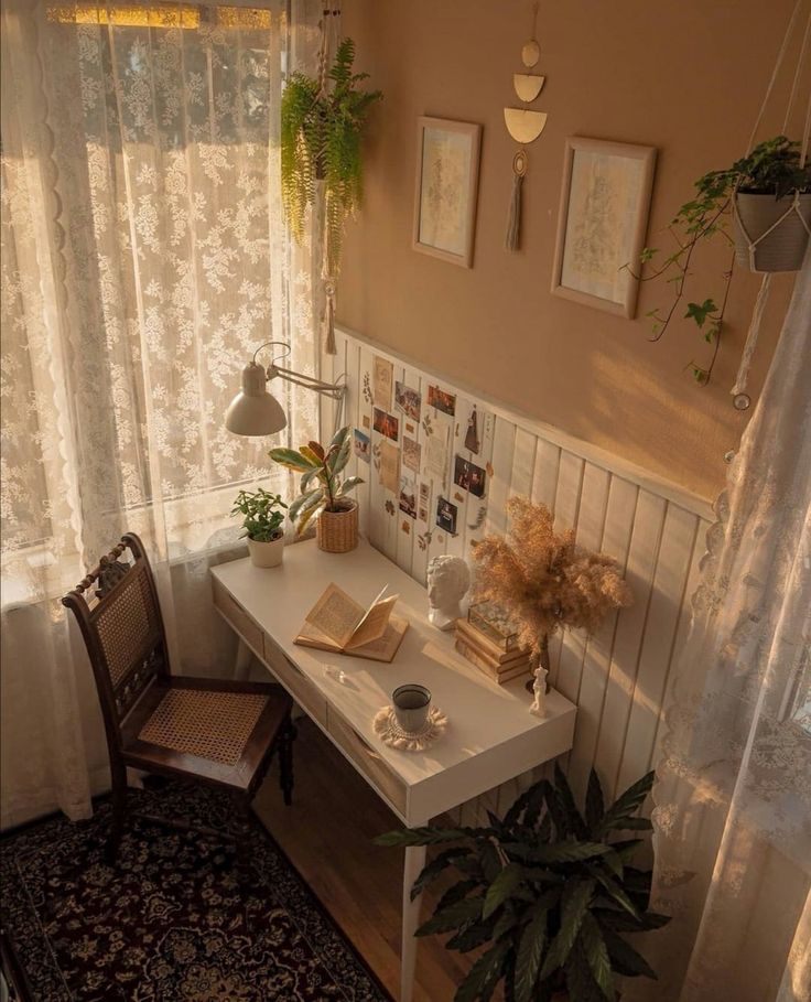 a room with a desk, chair and pictures on the wall next to a window