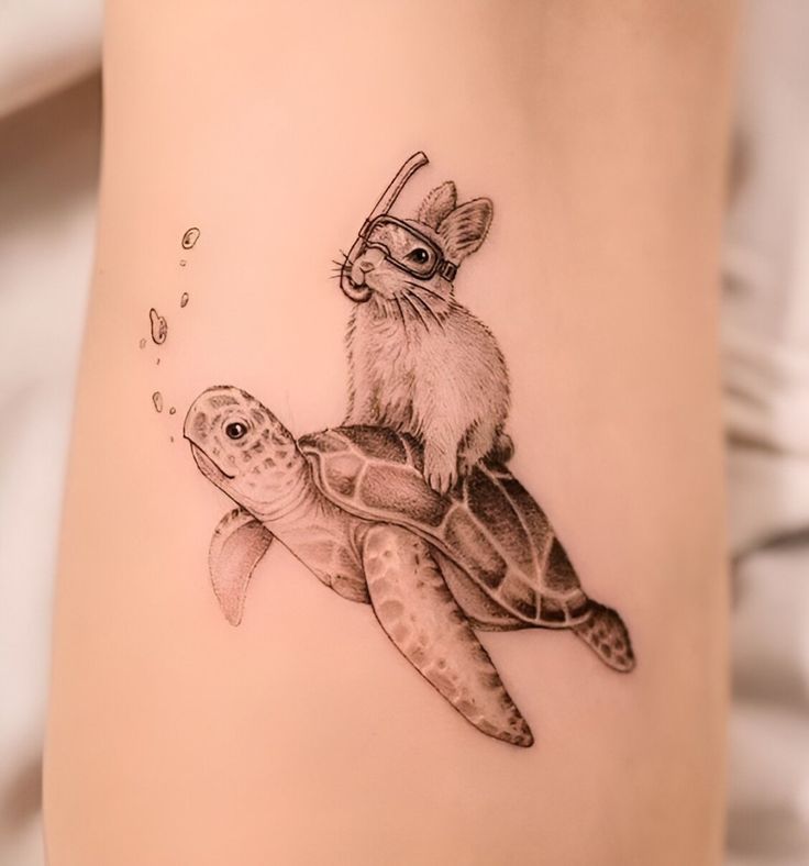 a tattoo with a rabbit riding on top of a turtle