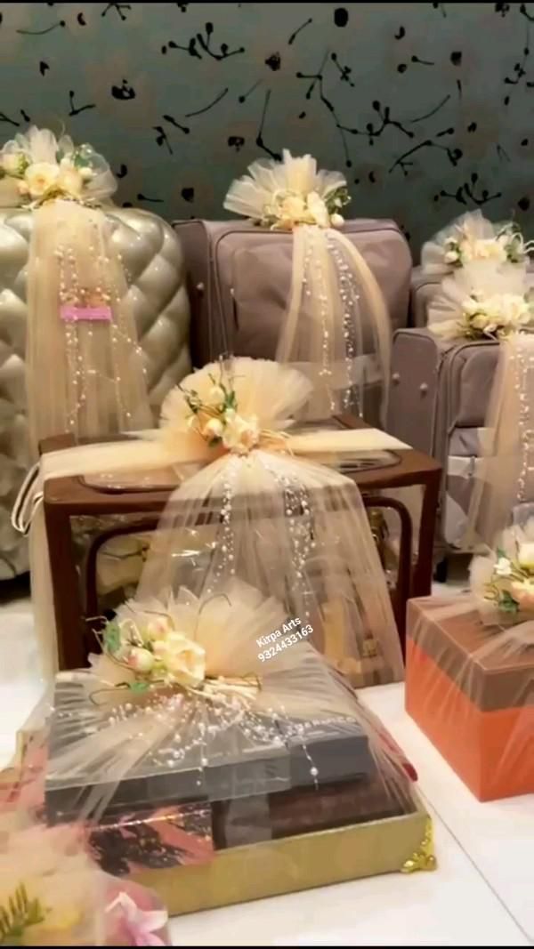 several boxes are wrapped in tulle and decorated with flowers