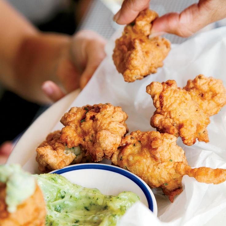 fried food is served on a plate with guacamole