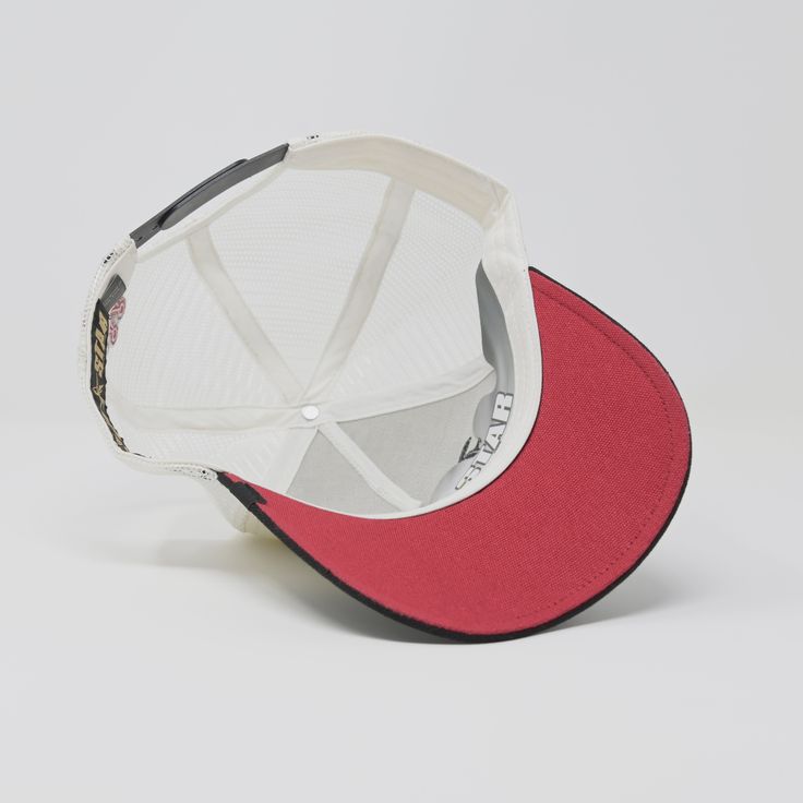 a red and white baseball cap on a white background