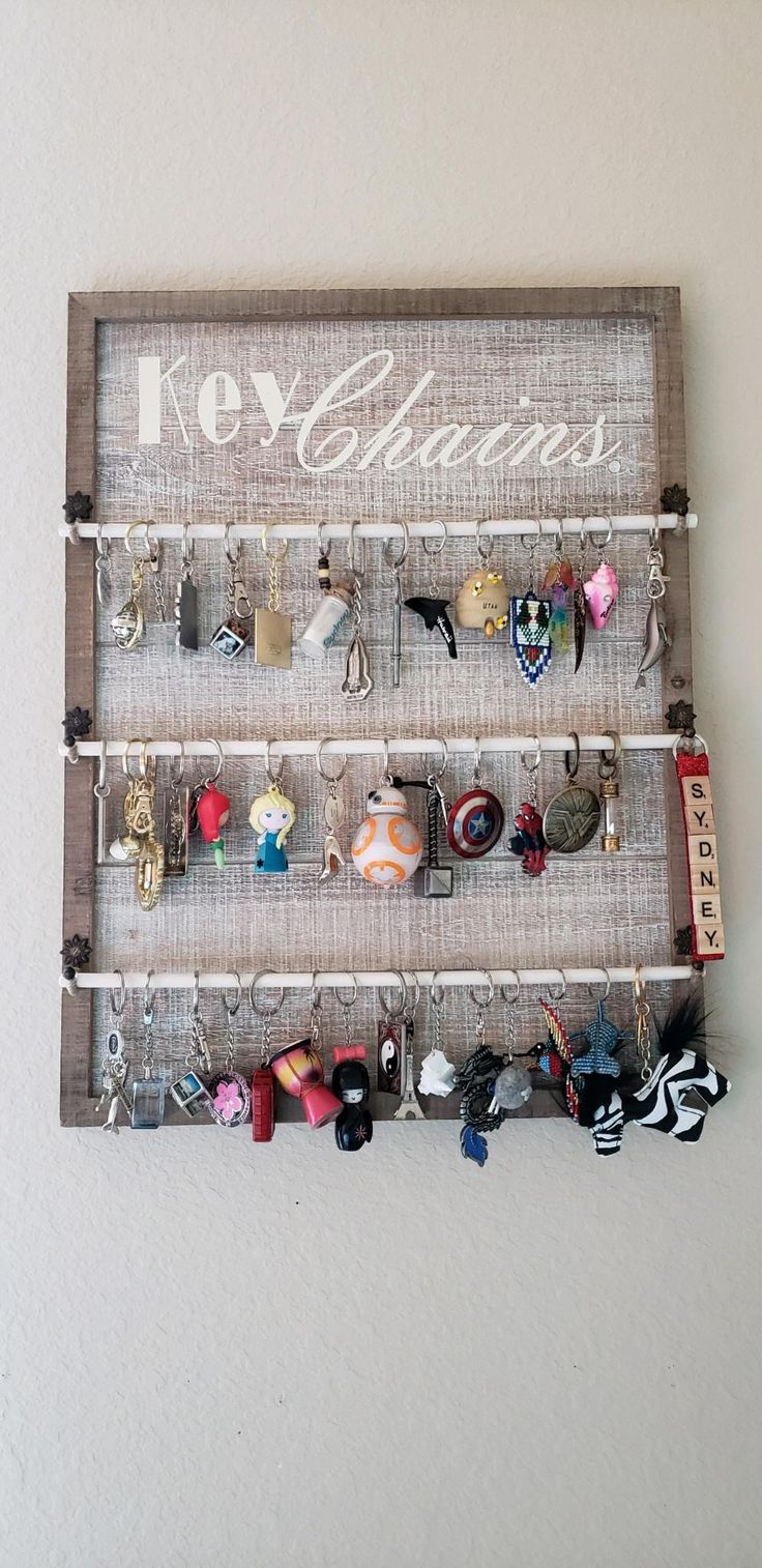 the key holder is made out of wood and holds many different types of jewelry on it