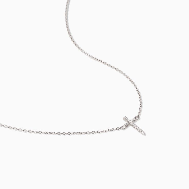 It’s not a T necklace, it’s our Simple Cross Necklace. Featuring a dainty, simple chain necklace and a pavé cross, this is the necklace your everyday look has been missing. Want to know the best part? Not only does this cross necklace come in gold, but you can also get it in Sterling Silver. Minimalist Clavicle Chain Necklace With Cross Pendant, Minimalist Cross Pendant Necklace With Clavicle Chain, Minimalist Cross Charm Necklace With Delicate Chain, Minimalist Sterling Silver Cross Necklace With Clavicle Chain, Simple Necklace With Delicate Chain And Cross Pendant, Minimalist Cross Pendant Necklace For Everyday Wear, Minimalist Cross Pendant Necklace For Everyday, Minimalist Cross Necklace For Everyday, Minimalist Charm Necklace With Cross Pendant And Adjustable Chain