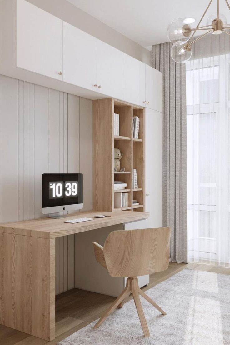 a room with a desk, chair and bookcase in the corner next to a window