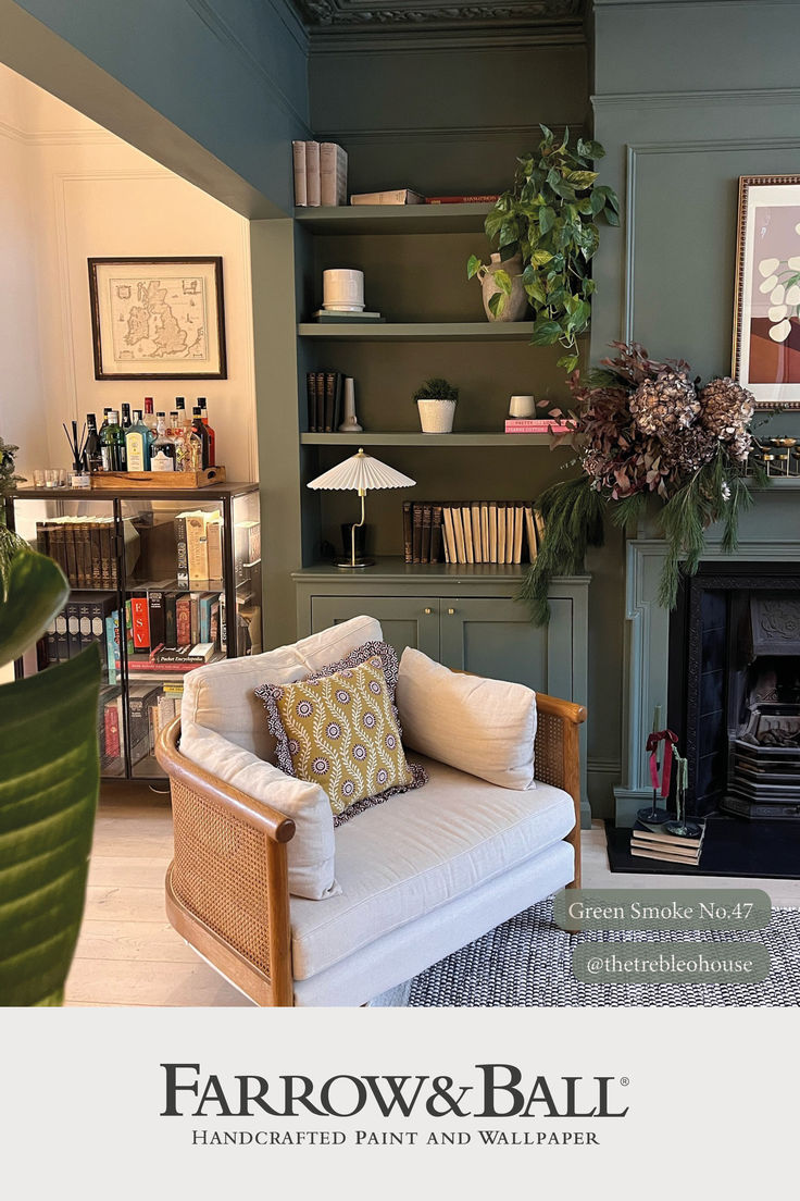 a living room filled with furniture and a fire place in front of a book shelf