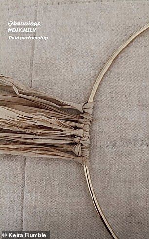 a close up of a piece of cloth on a table with a circular metal frame