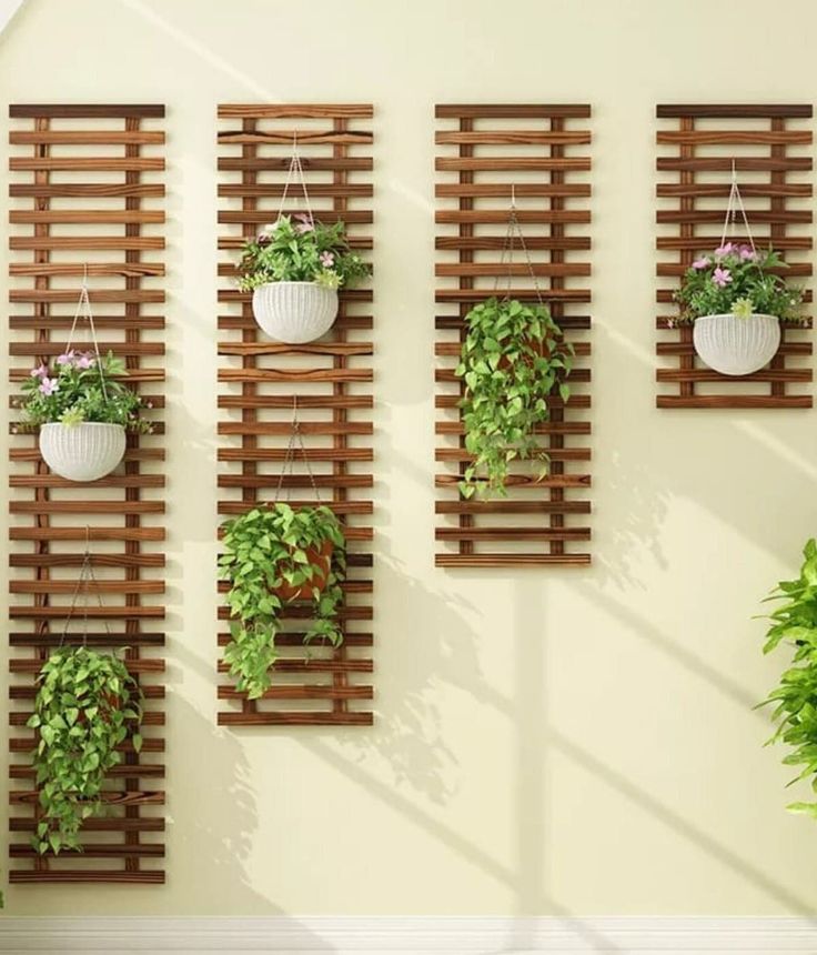 some plants are hanging on the side of a wall with wooden slatted boards