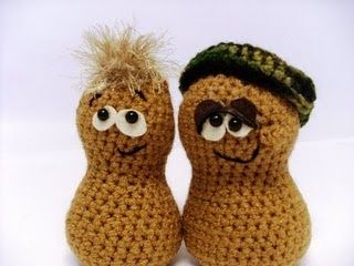 two crocheted toys with eyes and noses