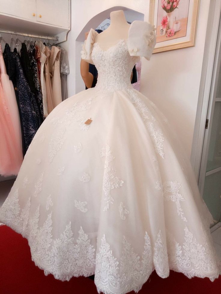 a white wedding dress on display in a store