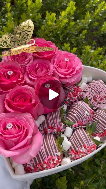 pink roses and chocolates in a heart shaped bowl