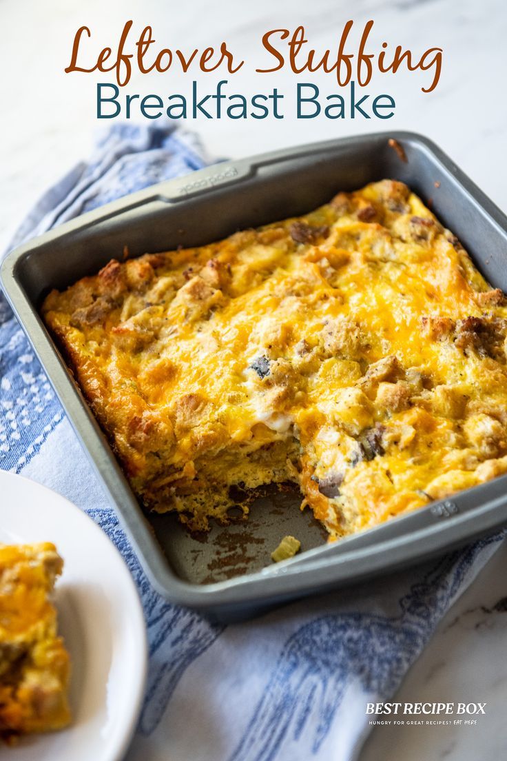 a casserole dish with meat and cheese in it on a blue towel next to a white plate