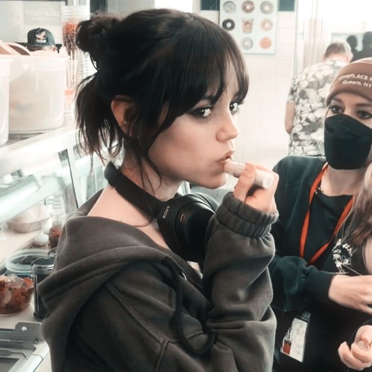 two women wearing face masks in a kitchen