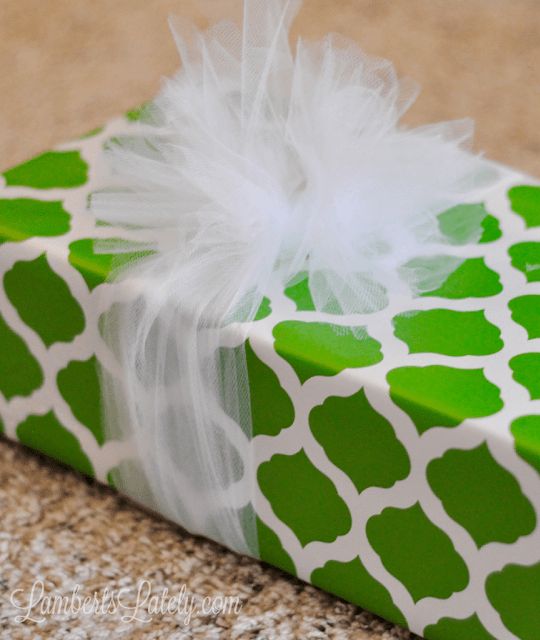 a green and white gift box wrapped in paper