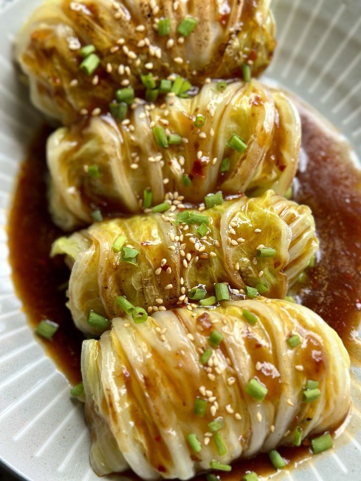 some food on a plate with sauce and green onions