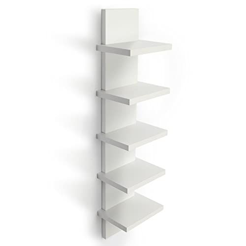 a white book shelf on the wall