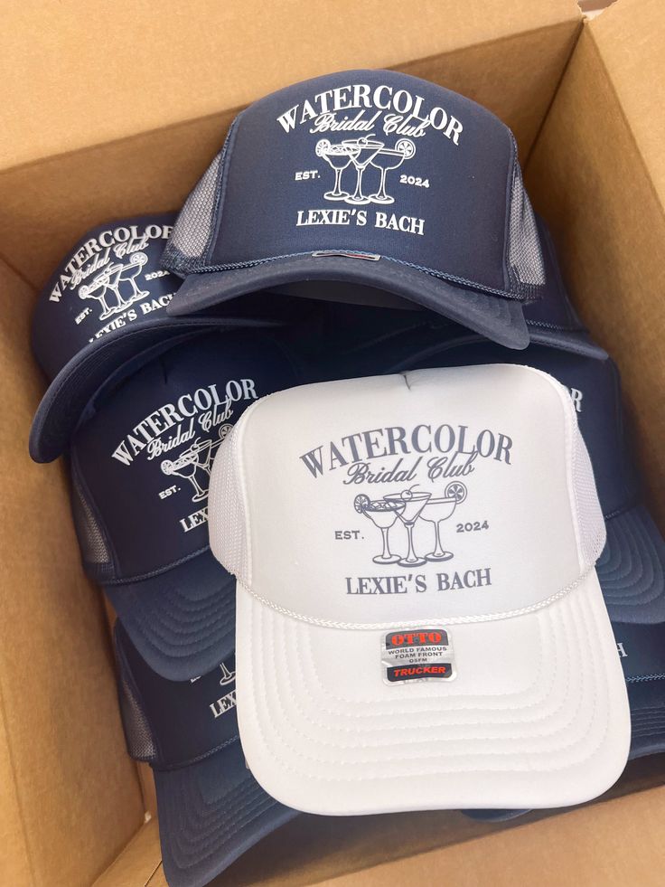 several hats in a cardboard box with the words watercolor next to each other on them