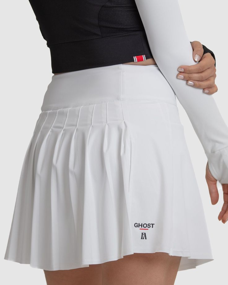 Introducing the Anika Golf Skirt, designed for a stylish and comfortable appearance on the course. Featuring built-in compression shorts with soft silicone grips, it ensures stability during swings. With its flattering silhouette and playful design, this skirt instills confidence for powerful shots. Elevate your golf wardrobe with the Anika Golf Skirt, a perfect blend of style and functionality. Fit: High-waisted design, sitting just above the belly button for a flattering silhouette. Featuring a 3 ¾” waistband with built-in tummy control for added comfort and support. Subtle A-line silhouette offers a stylish and versatile look. Front length measures 17 inches, providing ample coverage. Soft curve up at the side seam, starting at 15 ½” and gently curving back down to 17” at the back, ensu White 4-way Stretch Skirt With Built-in Shorts, Sporty Mini Length Lined Tennis Skirt, Sporty Mini Length Tennis Skirt With Lining, Athleisure Mini Tennis Skirt For Cheerleading, White Athleisure Mini Skirt, Cheerleading Tennis Skirt In Athleisure Style, White Fitted Pleated Swim Skirt, White 4-way Stretch Tennis Skort, White 4-way Stretch Tennis Skirt