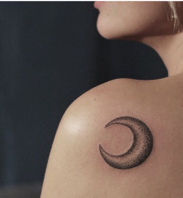 a woman with a crescent tattoo on her shoulder