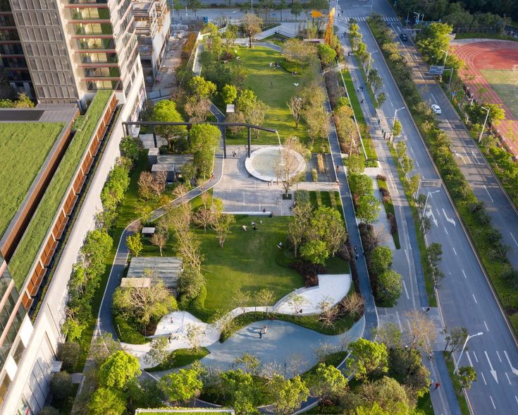 an aerial view of a park in the middle of a city with lots of trees