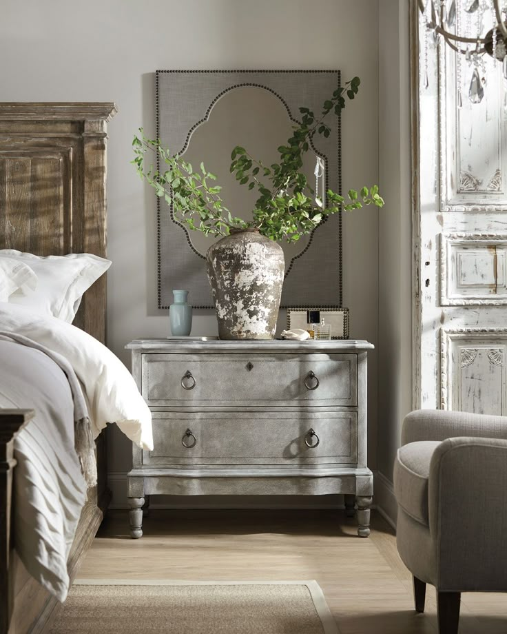 a bedroom with a bed, dresser and mirror in it's centerpieces