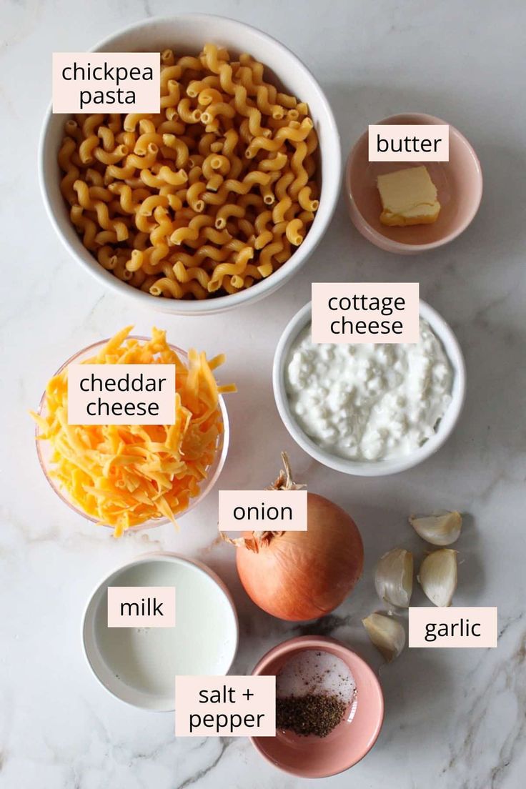 the ingredients for macaroni and cheese are shown in bowls