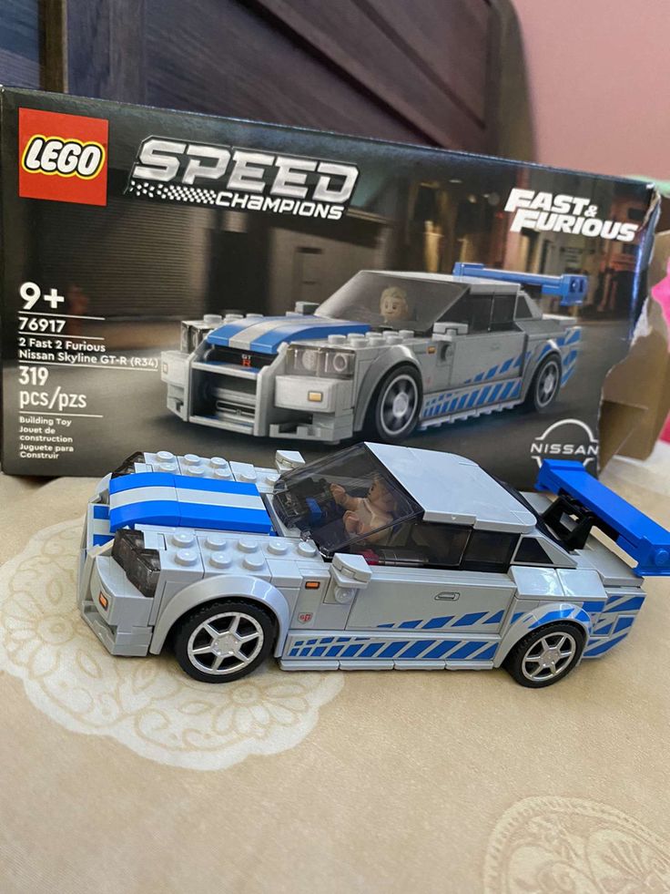 a lego speed car is shown in front of a box on the table with it's door open