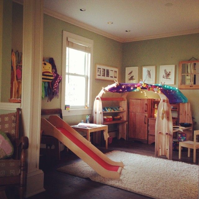 a child's play room with a slide in the middle