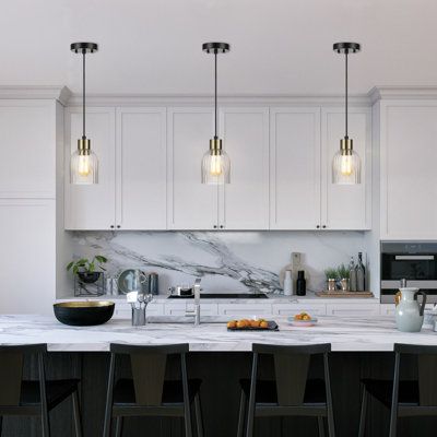 a kitchen with marble counter tops and bar stools