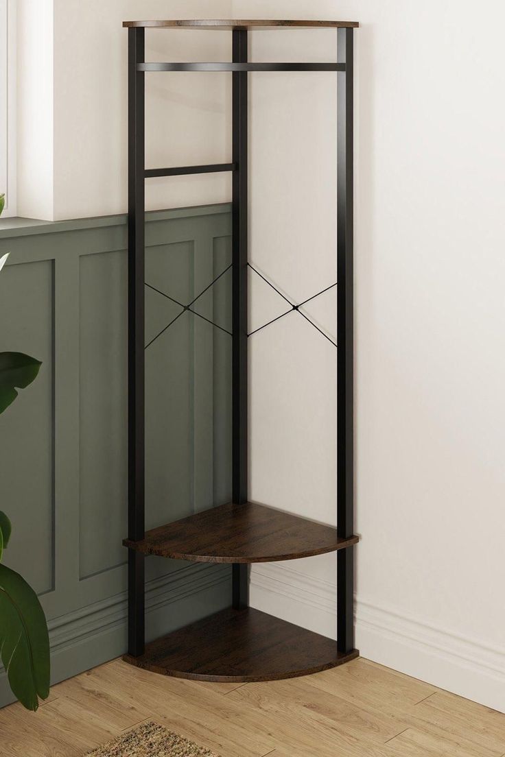 a corner shelf in the corner of a room with a potted plant next to it