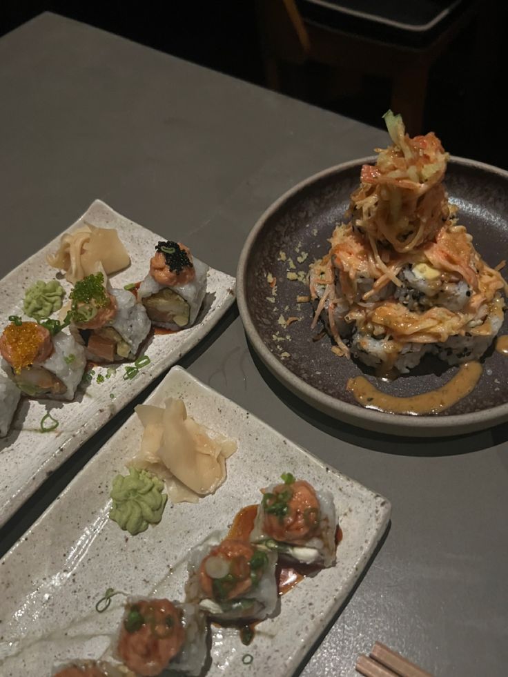 three plates with different types of sushi on them