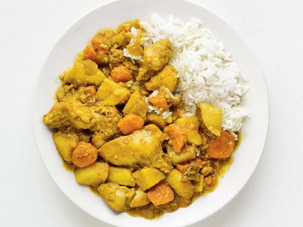 a white bowl filled with rice and chicken curry