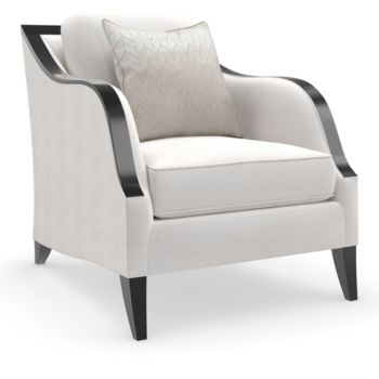 a white chair with black legs and a pillow on top of the armrests