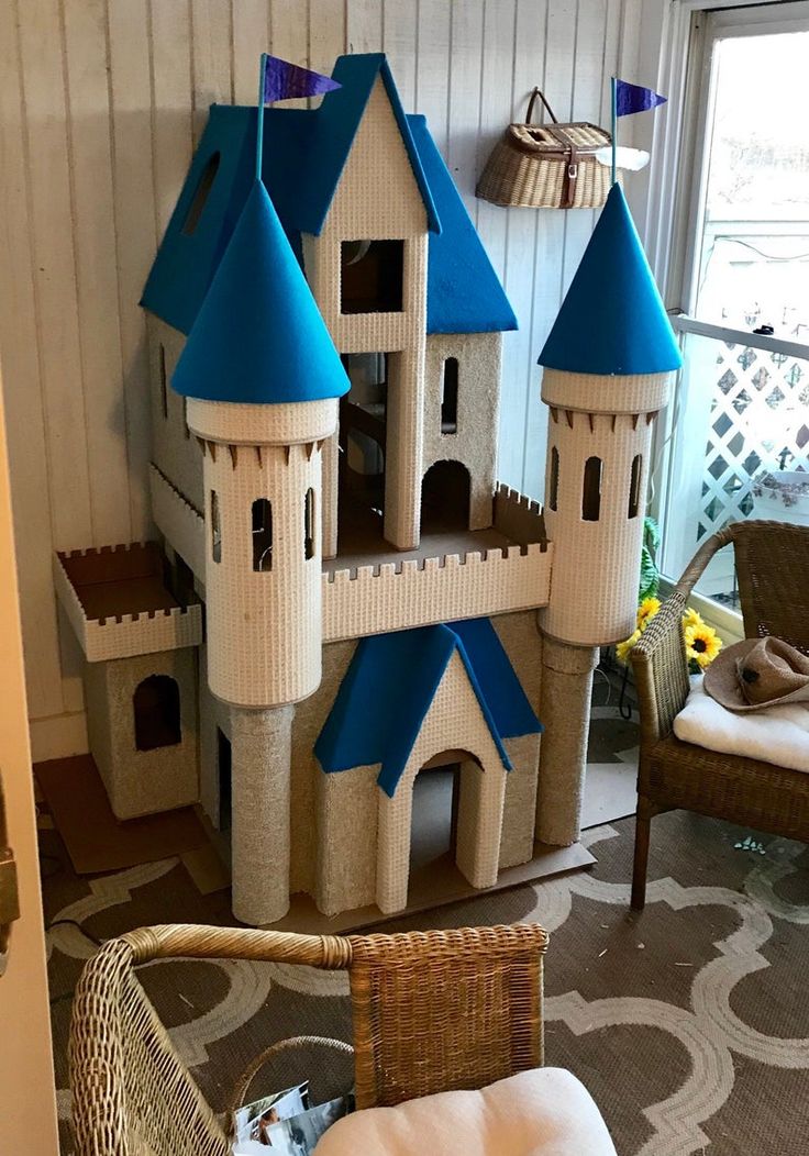 a castle made out of cardboard sitting on top of a rug