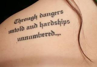 the back of a woman's shoulder with an inscription on it that reads, through danger