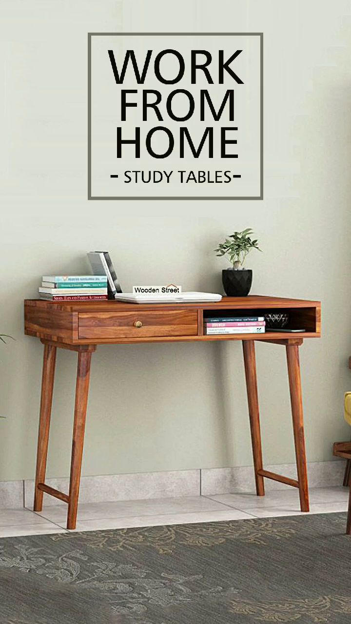 a wooden desk sitting in front of a wall with a sign above it that says work from home study tables