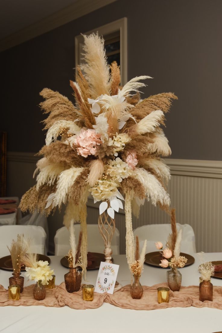 the table is decorated with feathers and flowers