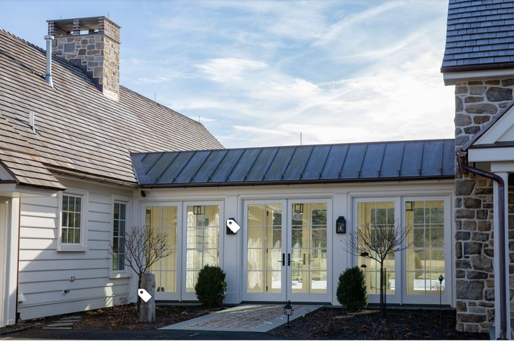 a white house with glass doors and windows