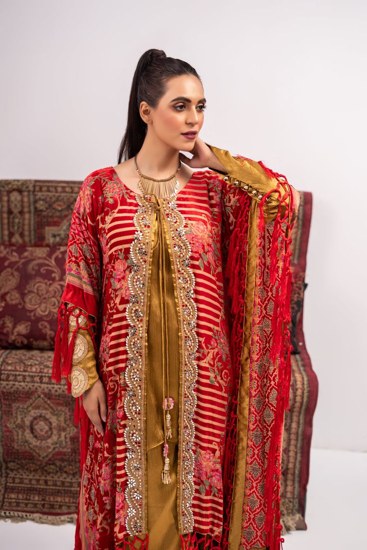 Discover luxury and elegance with our Red and Yellow Coat Shalwar Kameez. Made from plush materials, this front open poncho boasts intricate kundan work lace and resham tassels on each corner. The inner turmeric colored georgette silk shirt and pants add a touch of sophistication. Feel confident and stylish in this timeless piece. 3-Piece Suit Red Kaftan With Dupatta For Festivals, Festive Red Kaftan With Dupatta, Elegant Red Designer Wear Kaftan, Elegant Red Designer Kaftan, Designer Gold Kaftan With Dabka Work, Festive Kaftan With Dupatta For Eid, Anarkali Kaftan With Dupatta For Festive Occasions, Festive Red Kaftan, Elegant Red Kaftan For Diwali