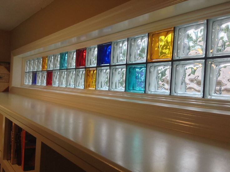 colorful glass block window with black grout in the center and white trim around the edges