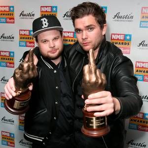 two men posing with their trophies at an awards event