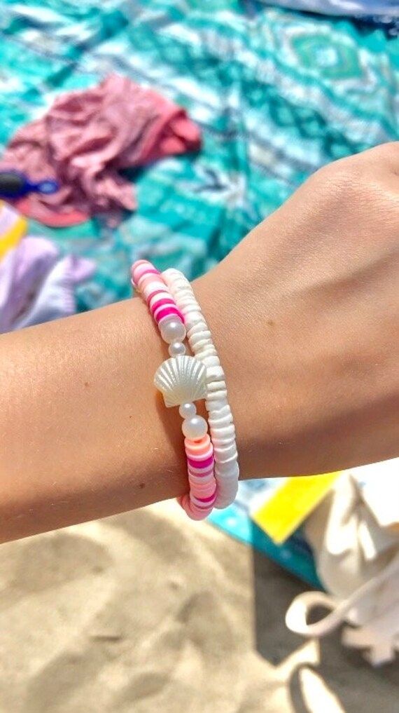 Cute bracelet stack, one pink clay bead bracelet along with a white bracelet! Pink Clay Bead Bracelet, Cute Beaded Bracelets, Bracelets Preppy, Sea Shell Bracelet, Preppy Bracelets, Bff Bracelets, Tropical Jewelry, Bracelet Stacks, Pink Sea