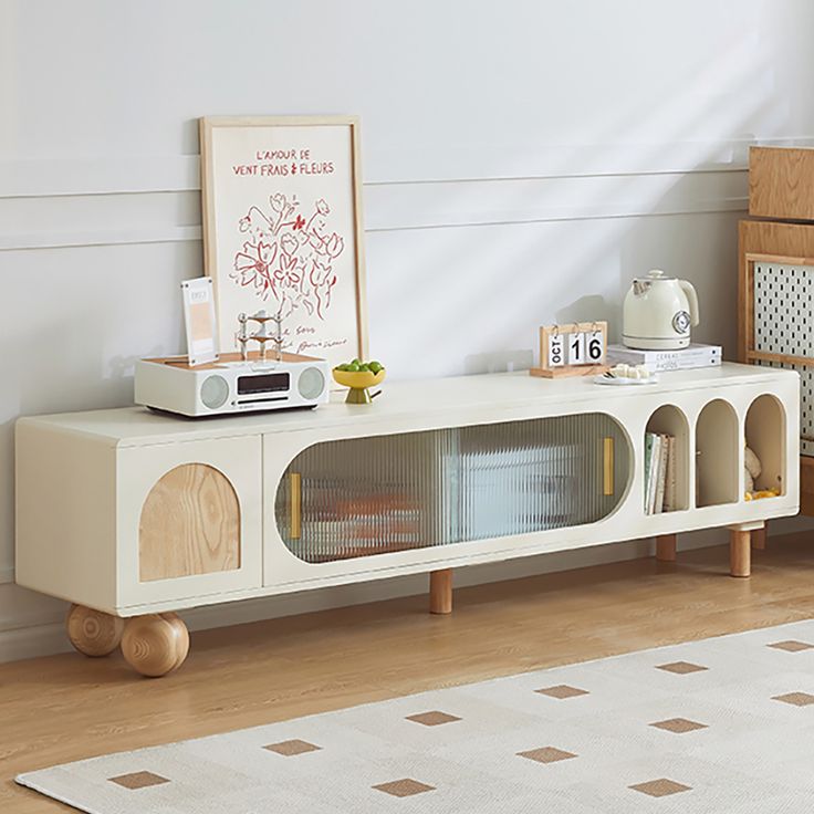 a living room with a white rug and a tv on top of a wooden stand