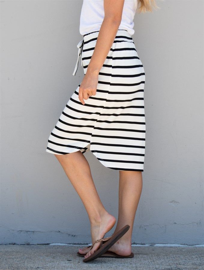 Hey there, fashion lovers! Get ready to add a new staple to your wardrobe with our Stripe Weekend Skirt in White Stripe. This skirt is perfect for any occasion, whether you want to dress it up or keep it casual. Made with super soft and lightweight fabric, this skirt is designed to provide comfort all day long. The knee-length and elastic waistband make it easy to wear for any body type. Plus, the white stripe pattern adds a touch of sophistication and elegance to your outfit. Pair it with a sim Versatile Midi Length Skirt For Day Out, Trendy Cotton Midi Bottoms, Trendy Cotton Midi-length Bottoms, Trendy Midi Length Cotton Bottoms, Trendy Midi-length Cotton Bottoms, Versatile Midi Skirt For Day Out, Cotton Midi Bottoms For Vacation, Versatile Midi-length Bottoms For Day Out, Versatile Midi Length Bottoms For Day Out