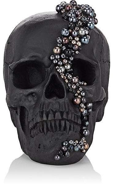 a black skull with pearls on it's head